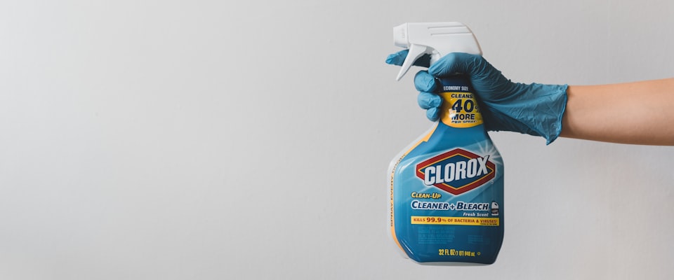 Non-toxic dish soap bottles on a clean kitchen counter next to a ceramic sink