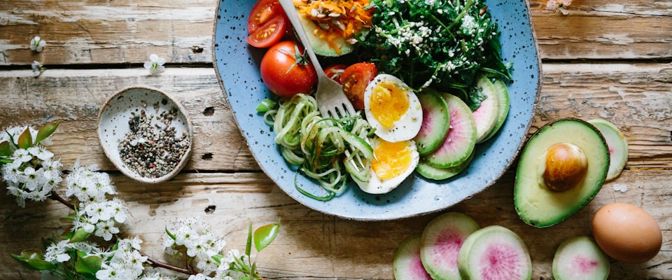 Fresh food stored in glass containers on a warm wooden kitchen counter
