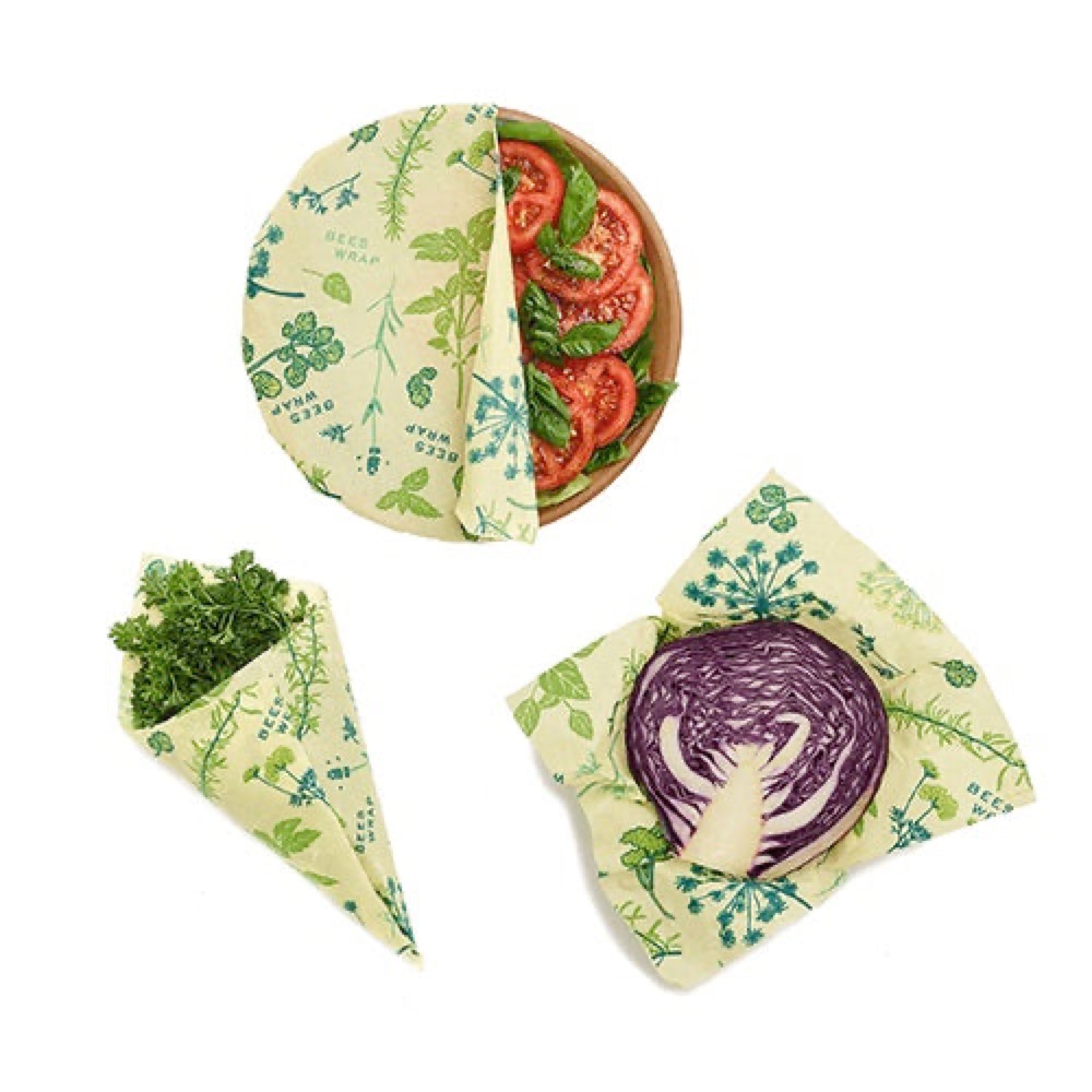 Bee's Wrap Vegan Plant-Based 3-Pack — candelilla-wax wraps in a green herb print covering a bowl of tomatoes, herbs, and a cut red cabbage