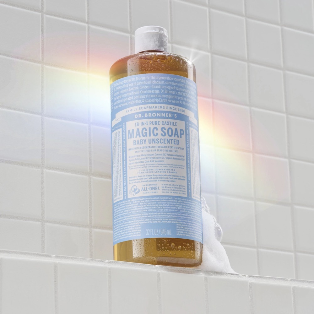 Dr. Bronner's Baby Unscented Pure-Castile Liquid Soap 32oz bottle on a white-tile ledge — USDA Organic, five ingredients