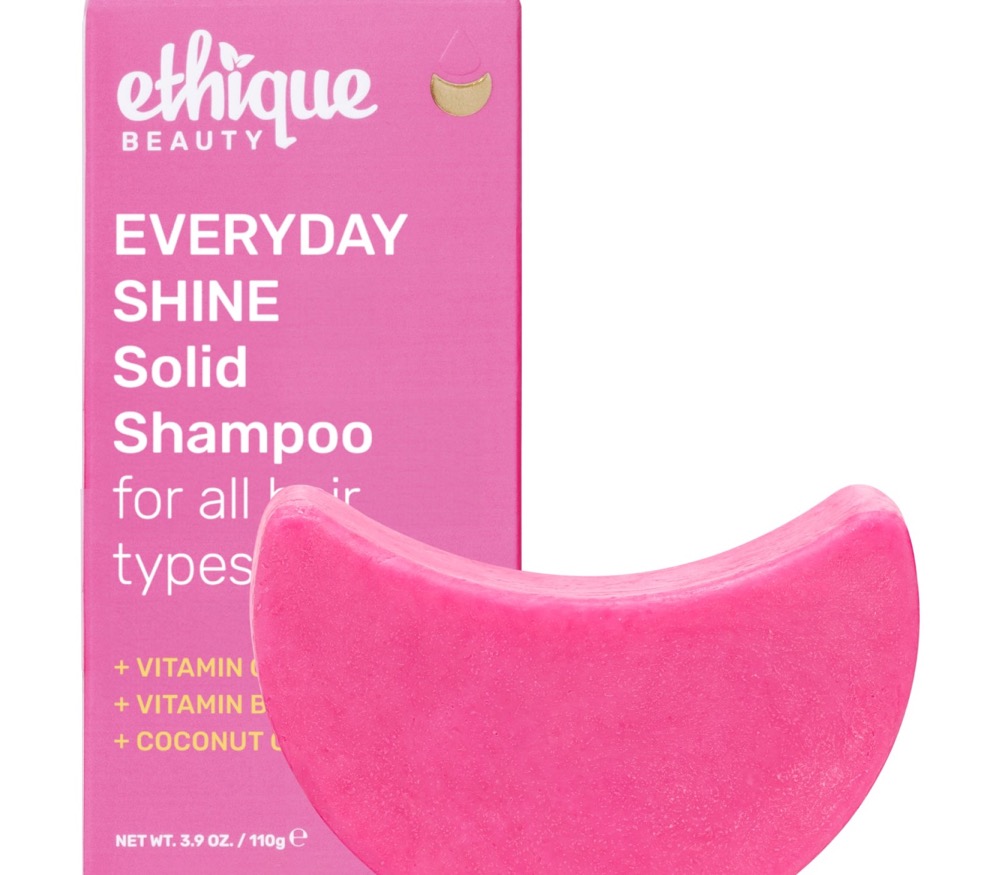 Ethique Everyday Shine solid shampoo bar (formerly Pinkalicious) — pink crescent bar beside its pink compostable Ethique box with vitamin C and coconut oil, color-safe for all hair types