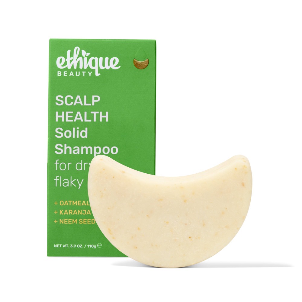 Ethique Heali Kiwi solid shampoo bar — cream crescent bar beside its green compostable Ethique box with oatmeal, karanja and neem