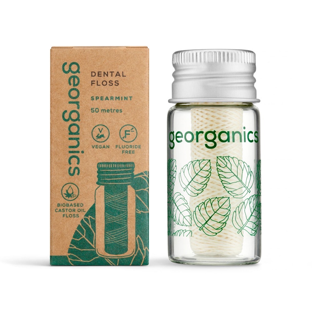 Georganics spearmint natural dental floss — plant-based vegan floss in a refillable glass jar next to its recyclable kraft box