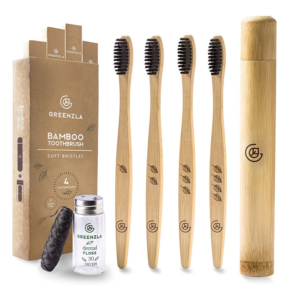 Greenzla bamboo toothbrush 4-pack with smooth-finish bamboo handles, charcoal-infused soft black bristles, a bamboo travel case, and charcoal dental floss