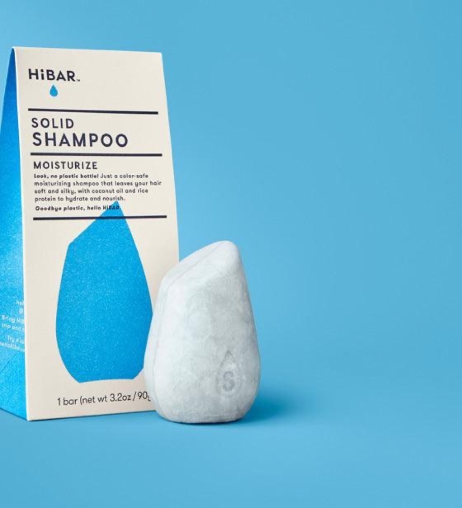 HiBAR Moisturize solid shampoo bar — white bar beside its blue-and-white cardboard HiBAR box with shea butter and argan oil for curly hair