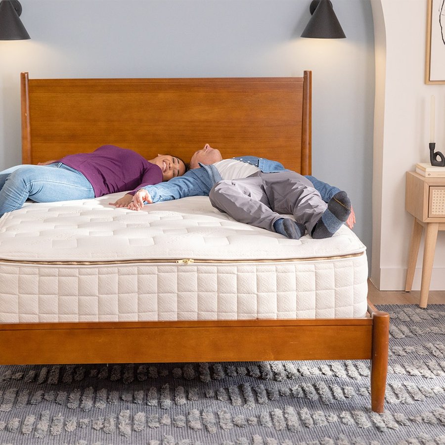 Naturepedic EOS Classic organic mattress — GOTS organic cotton over coils, shown on a wood bed frame
