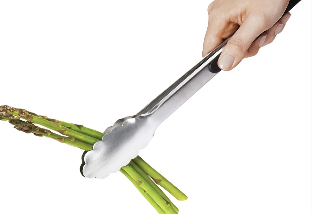 OXO stainless steel tongs gripping asparagus