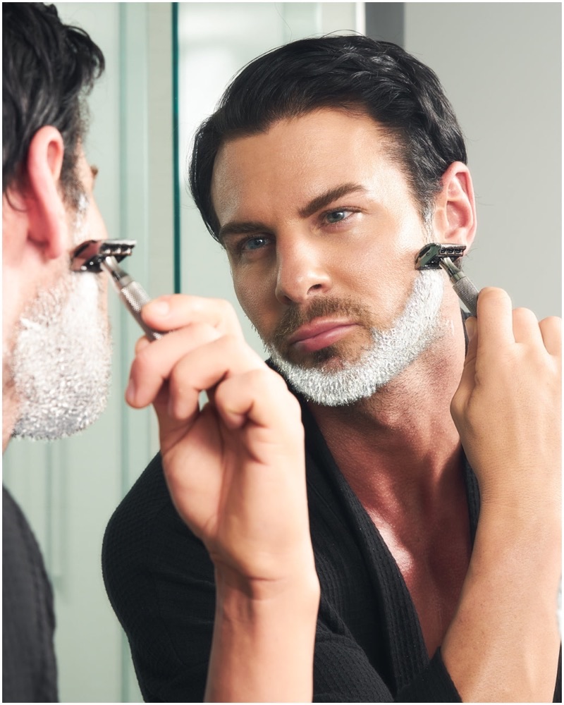 A man shaving with the chrome Rockwell 6C adjustable safety razor — a metal double-edge razor with six interchangeable shave settings