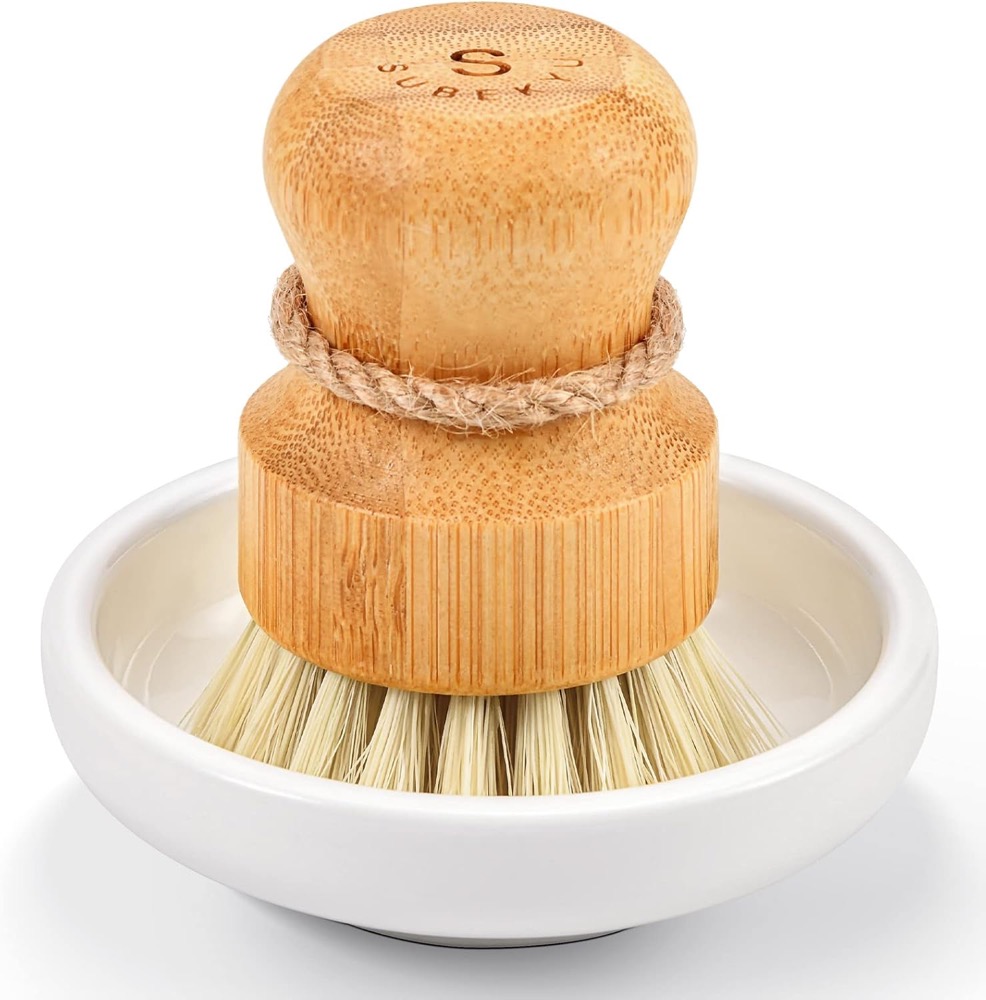 SUBEKYU bamboo palm dish brush with natural sisal bristles resting in a ceramic holder dish — plastic-free