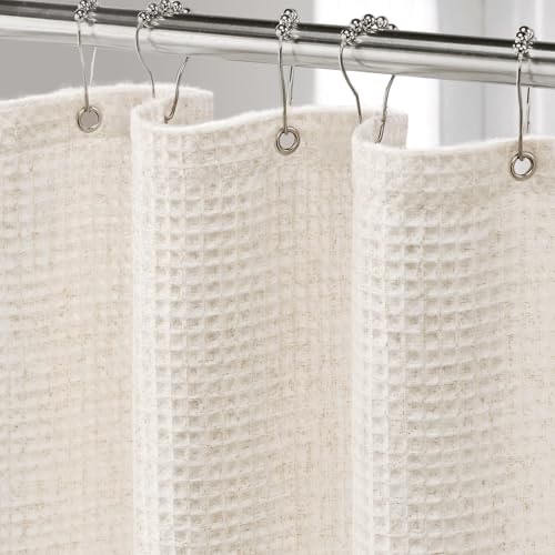Cream linen waffle-weave shower curtain with a textured natural-fabric surface, hanging in a bright bathroom