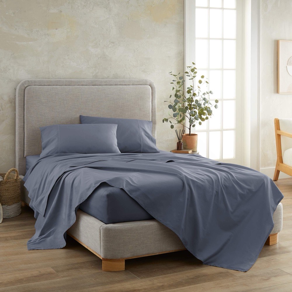 Whisper Organics 100% Organic Cotton Sheet Set — GOTS-certified 300 thread count sateen made up on a bed in mineral blue