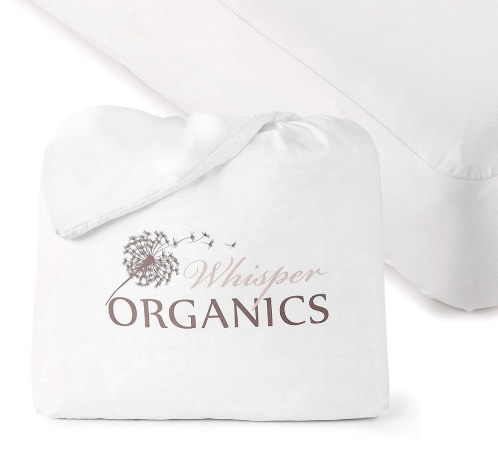 Whisper Organics waterproof crib mattress protector fitted on a mattress corner, shown with its branded organic cotton storage pouch